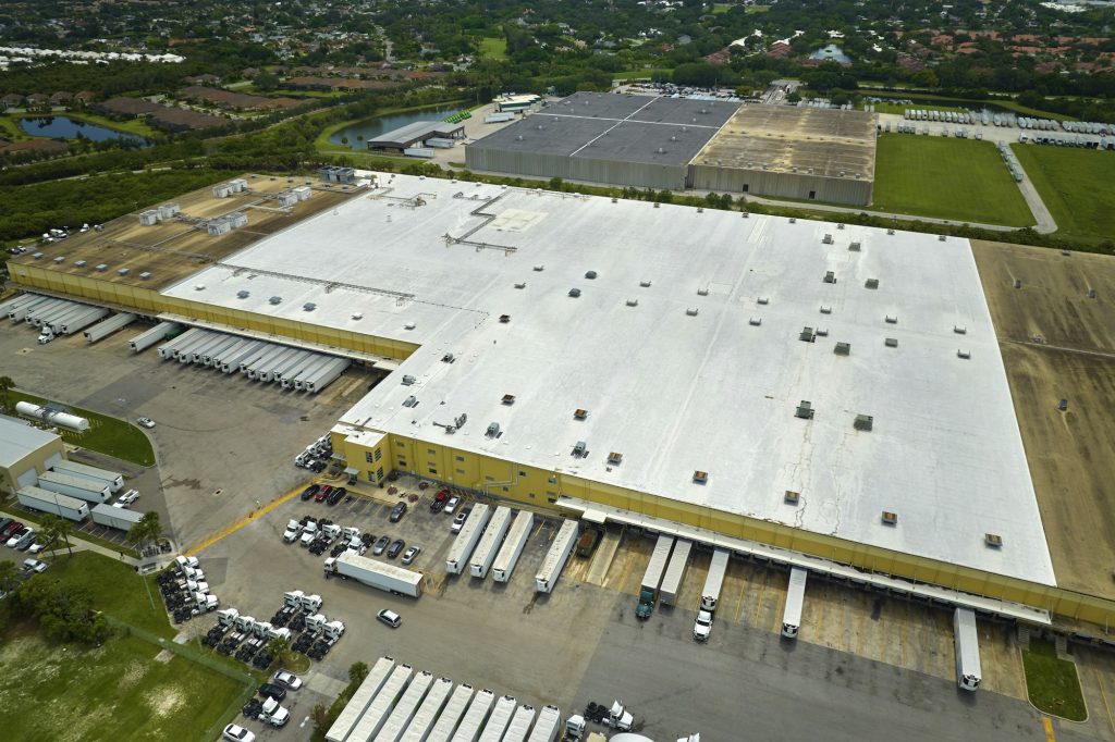 Big corporate shipment center with many cargo semi trucks